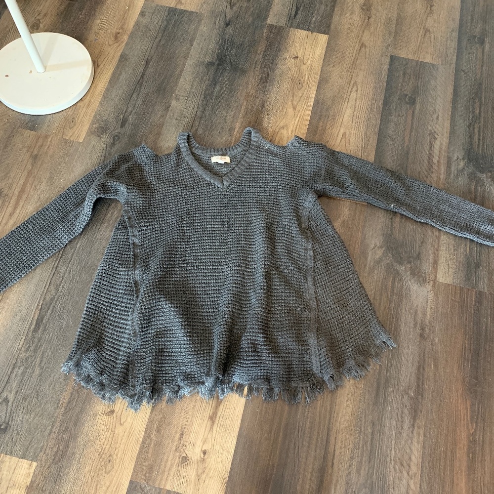 Umgee waffle knit cold shoulder fringed sweater in charcoal.